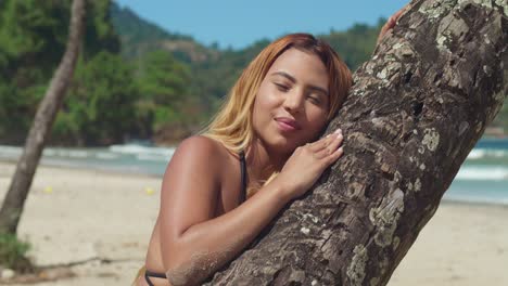 a youthful girl in a bikini enjoys a caribbean beach with white sands