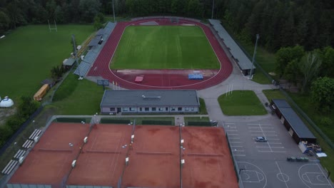 sports stadium complex with different courts, aerial drone zooming in view