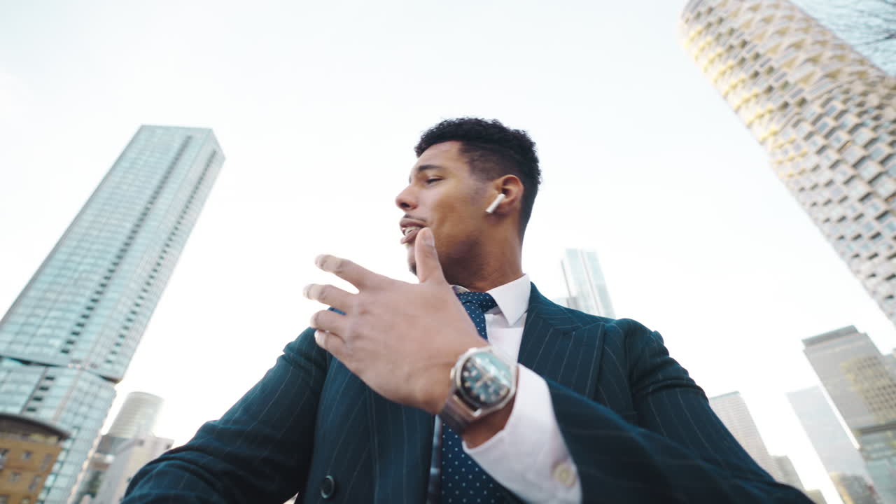 Young Businessman Talking and Smiling in Modern City Environment