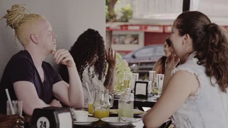 Diverse group of friends socializing at a restaurant