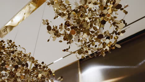 closeup of gold hanging chandelier inside the house