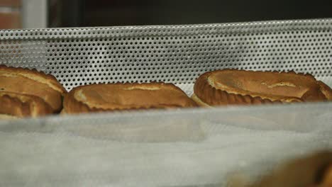 freshly baked bread in an aluminum rack at the bakery