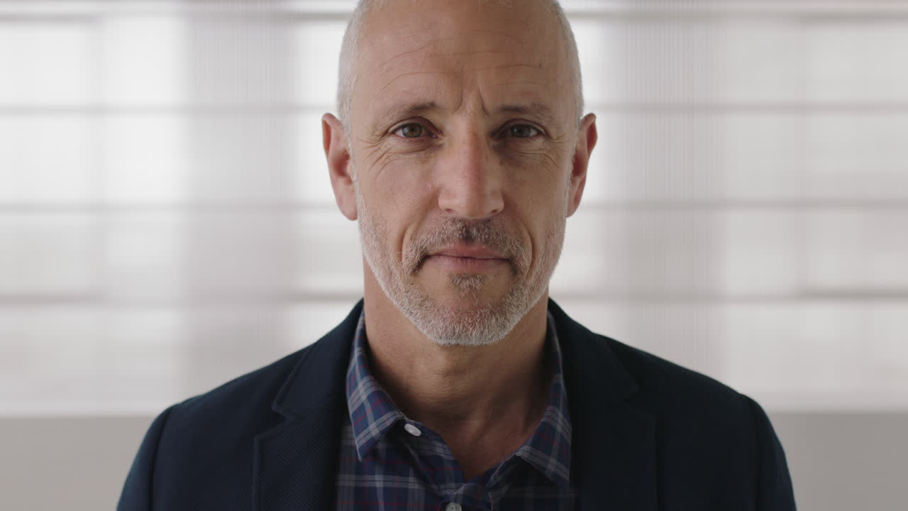 close up portrait of attractive mature businessman looking serious confident at camera professional caucasian male