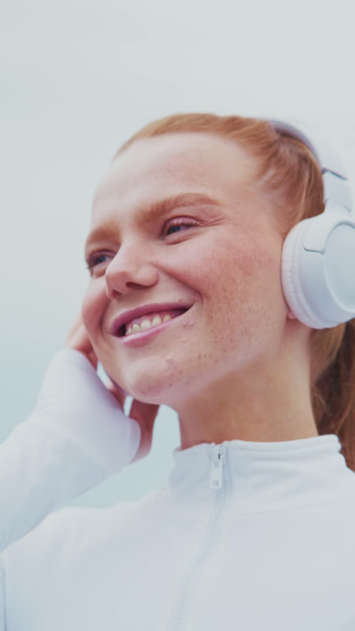 A Young Woman Enjoying Music with Headphones, Capturing the Essence of Joy and Connection Through Sound in a Bright and Uplifting Atmosphere