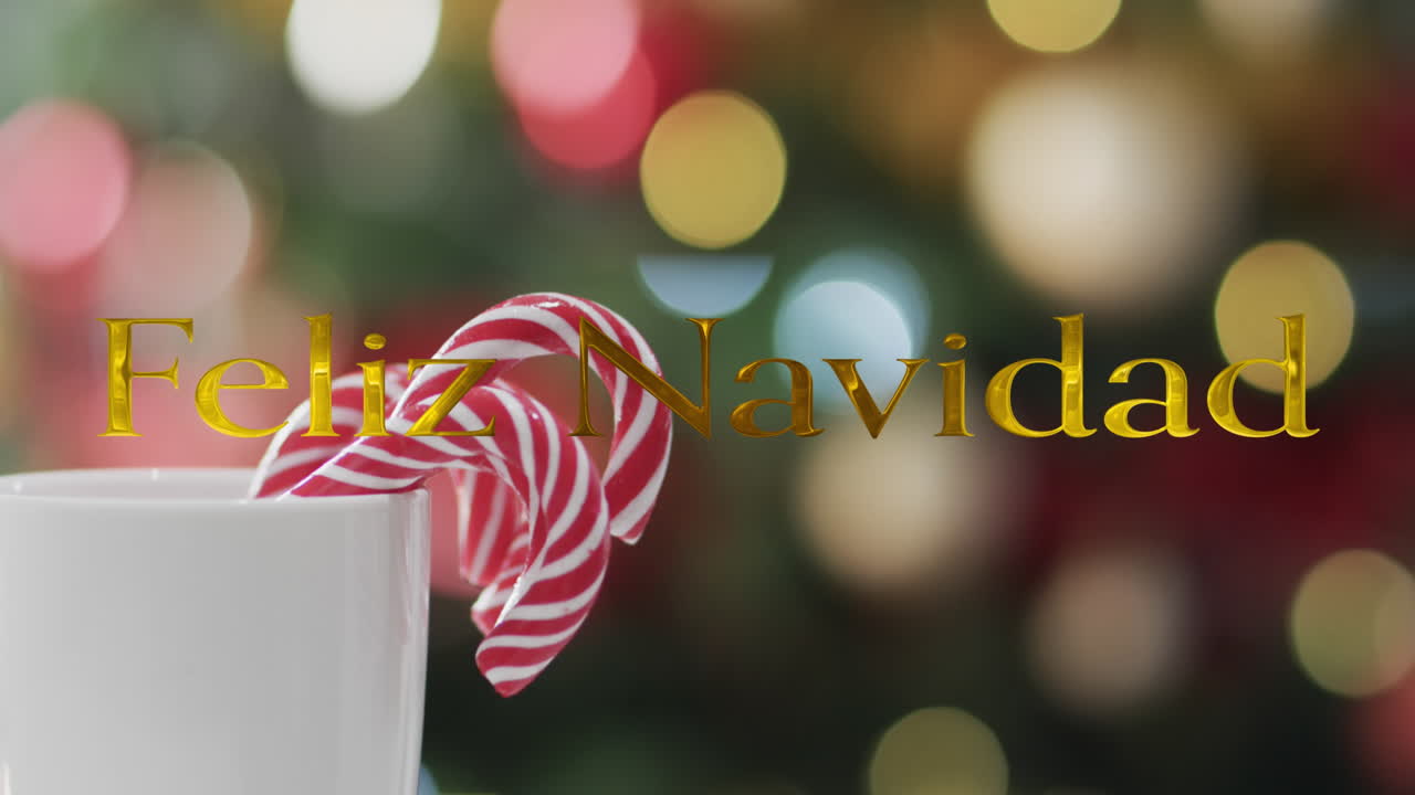 texto de feliz navidad en oro sobre bastones de caramelo y luces de navidad bokeh