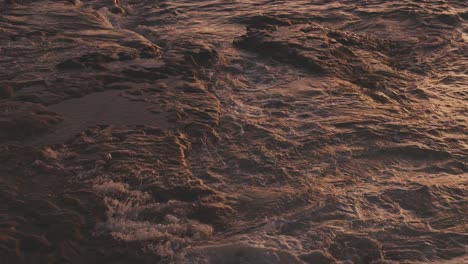 Ocean-splashing-on-rock,-sunset-on-wharf-at-La-Parouse-Beach