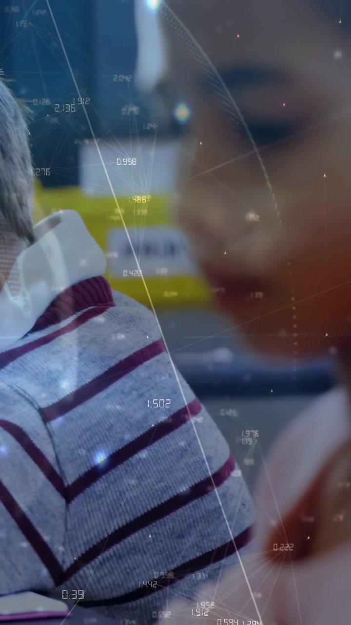 Girl sitting, boy leaning over book in class, camera focus shifting showing stripes overlaying data