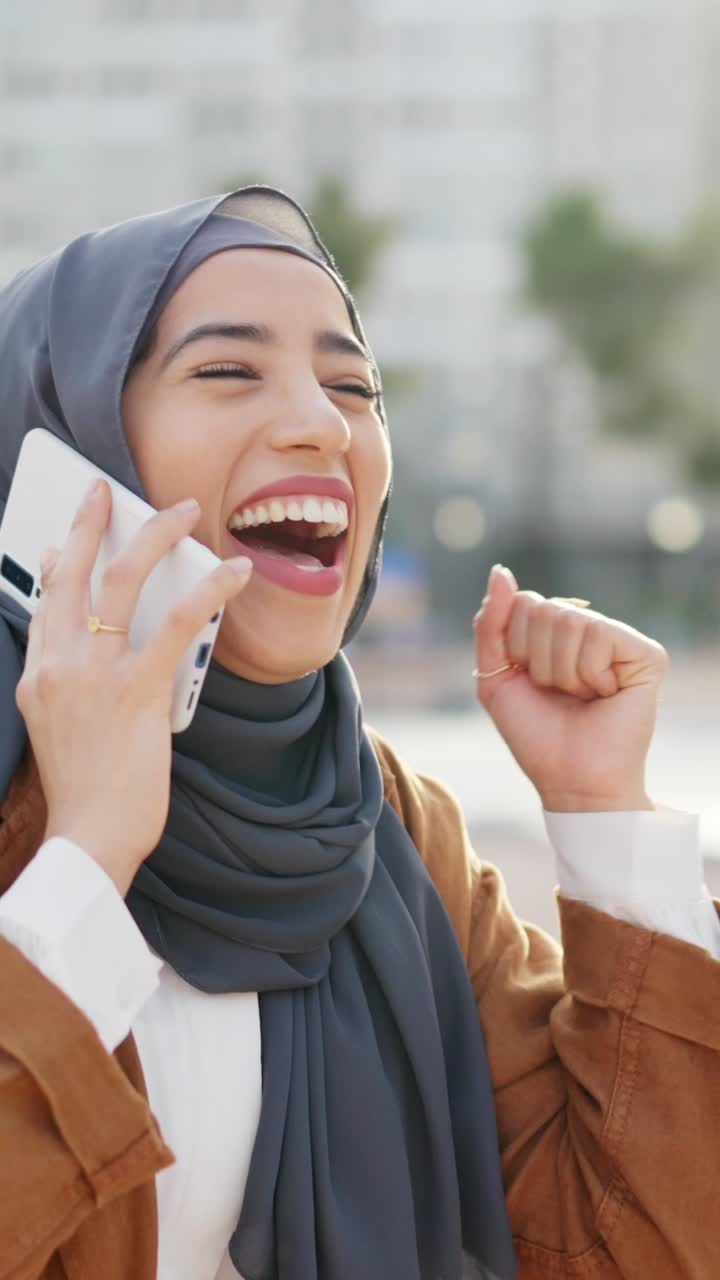 Joyful Muslim Woman Celebrates Good News on a Phone Call Outdoors