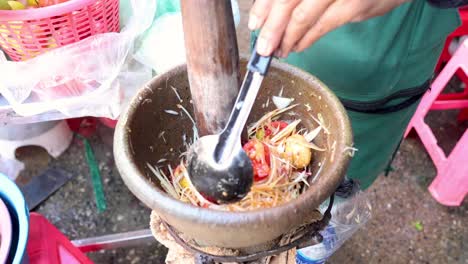 sequential preparation of a spicy papaya salad dish