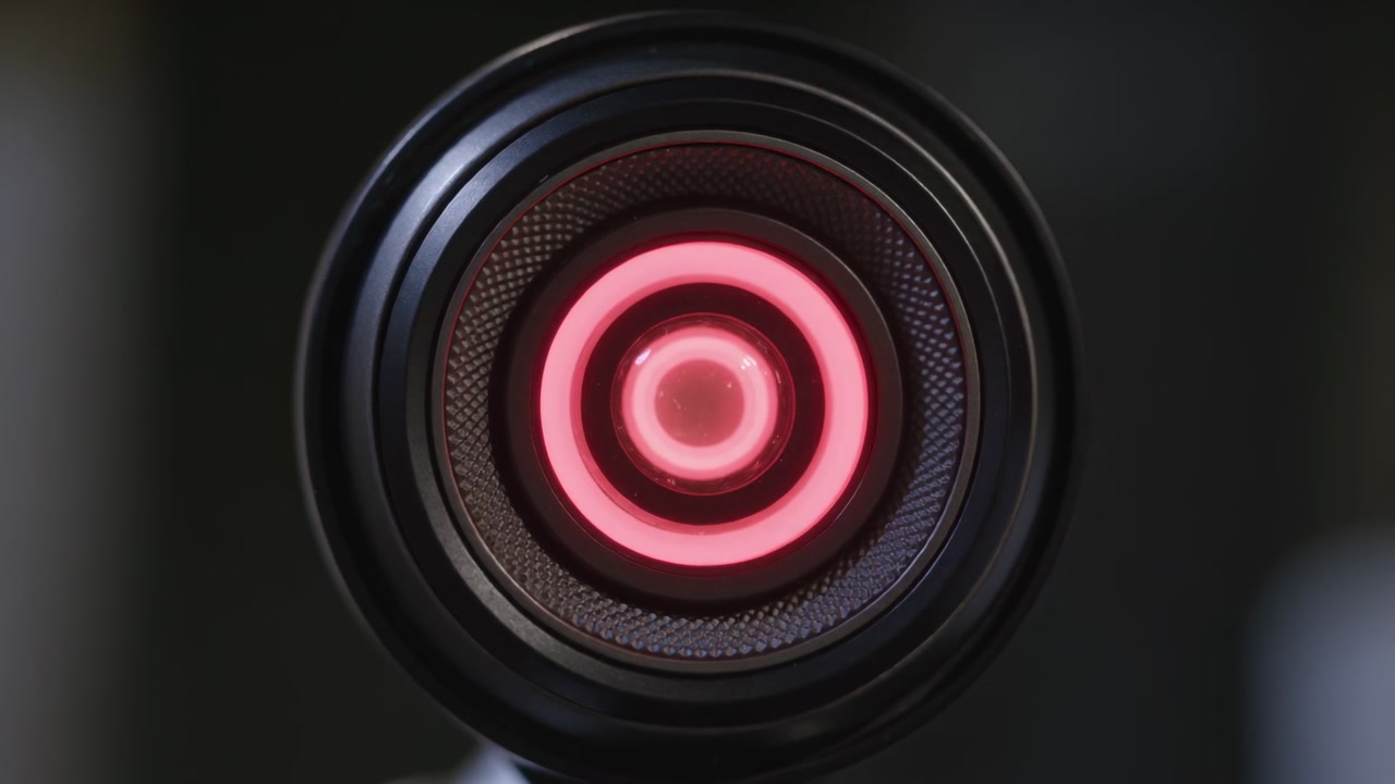 Sensor assembly cycling LED rings on power-up in tech lab, rings shifting colors to show status