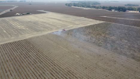 traveling drone footage of farmer's working the california fields