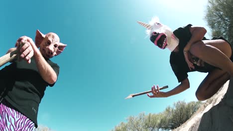 two killers in horse and pig masks pose threateningly with axes and shovels