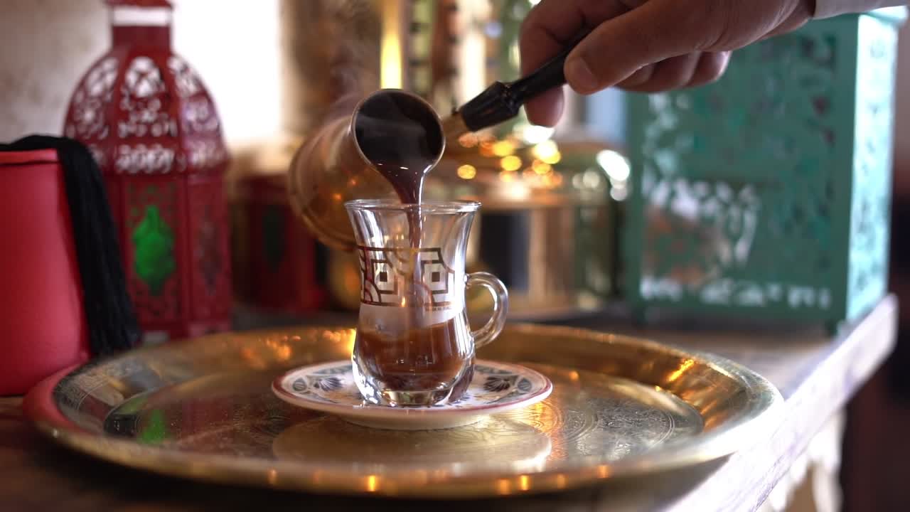 A man pours coffee on a cup, close up shot, insert shot