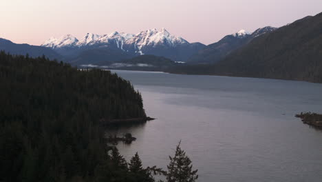 morning light on snowy nimpkish mountains and lake