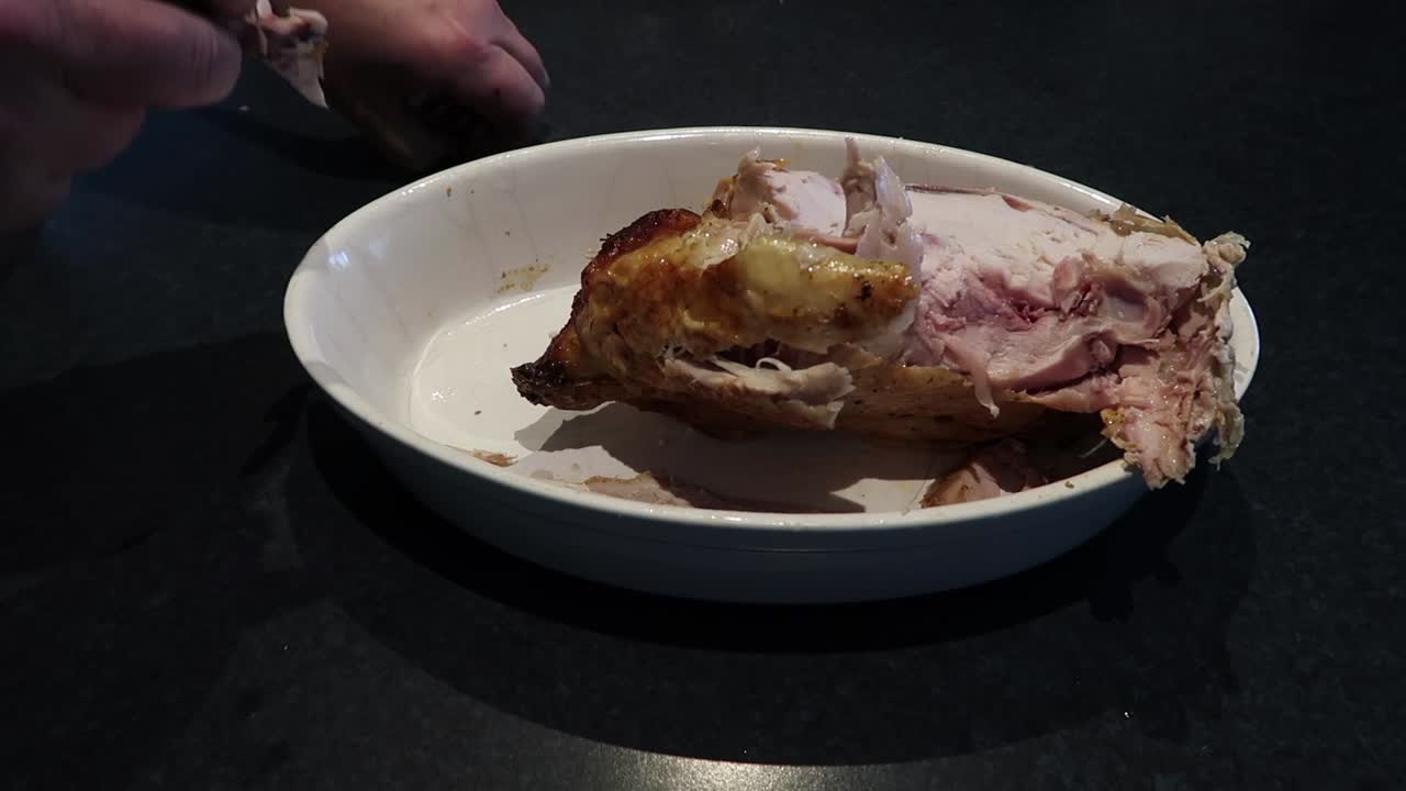 Man pulling chicken apart - Chicken not properly cooked