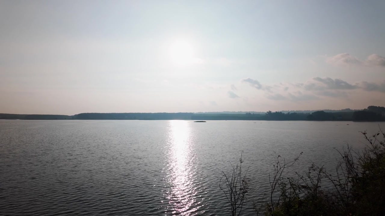 Watch as the sun reflects on the water at Ho Bong Trang in Vung Tau, Vietnam. This takes place in the afternoon, creating a bright view of the landscape.
