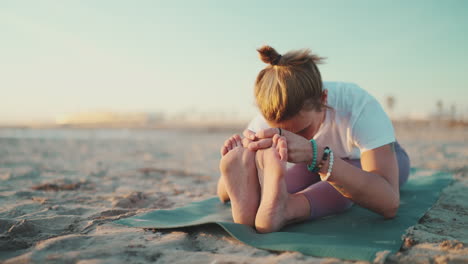 young woman doing yoga exercise outdoors.