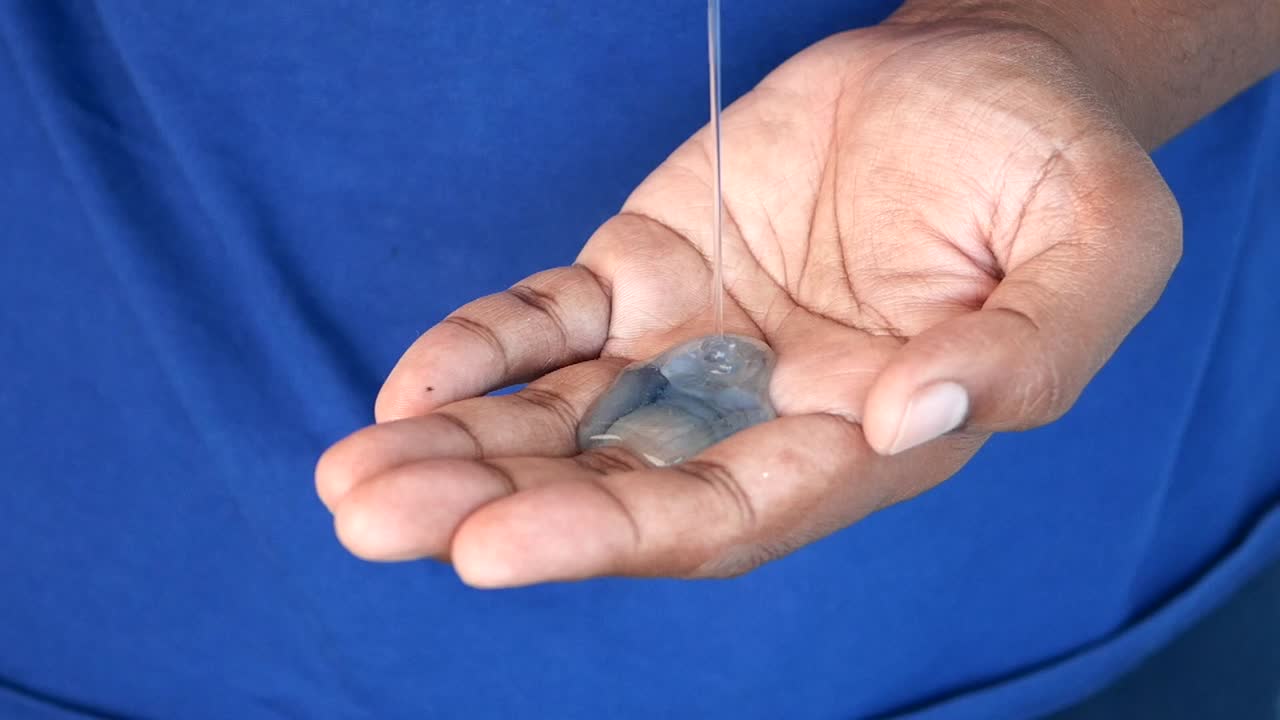 Hand holding a liquid substance