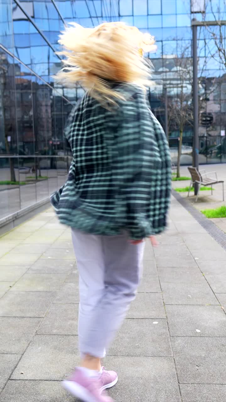 Woman dancing in urban environment