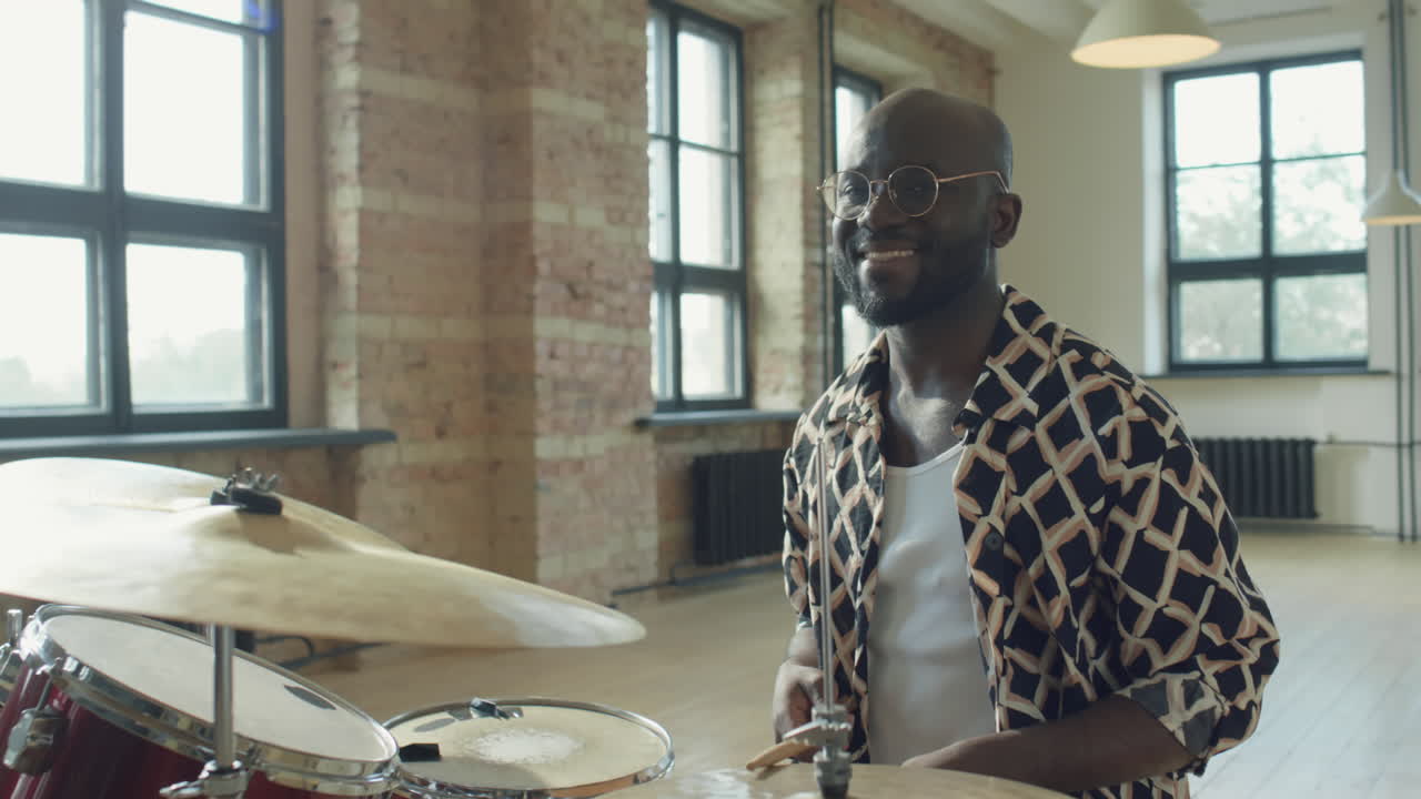 Portrait of Cheerful African American Drummer at Drum Set