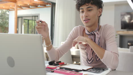 applying makeup, non binary person using laptop for online tutorial at home