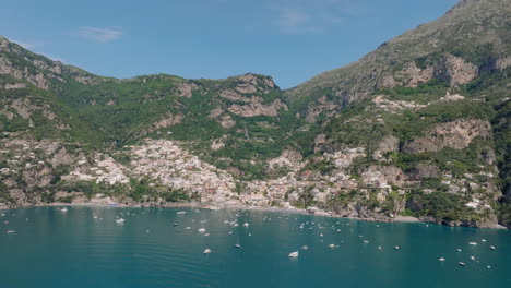 aerial: slow panning panoramic drone shot of positano in amalfi coast of italy during a sunny day