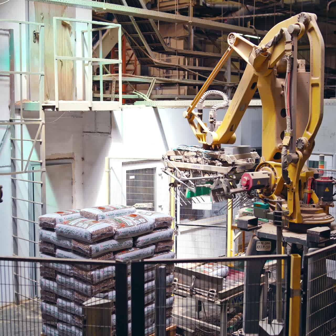 Industrial robot. Robotic arm working on the modern plant. Automated production in factory. Manufacturing workshop.