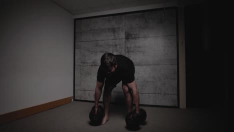 Dumbbell-Romanian-deadlift,-cinematic-lighting,-white-man-dressed-in-black-gym-attire