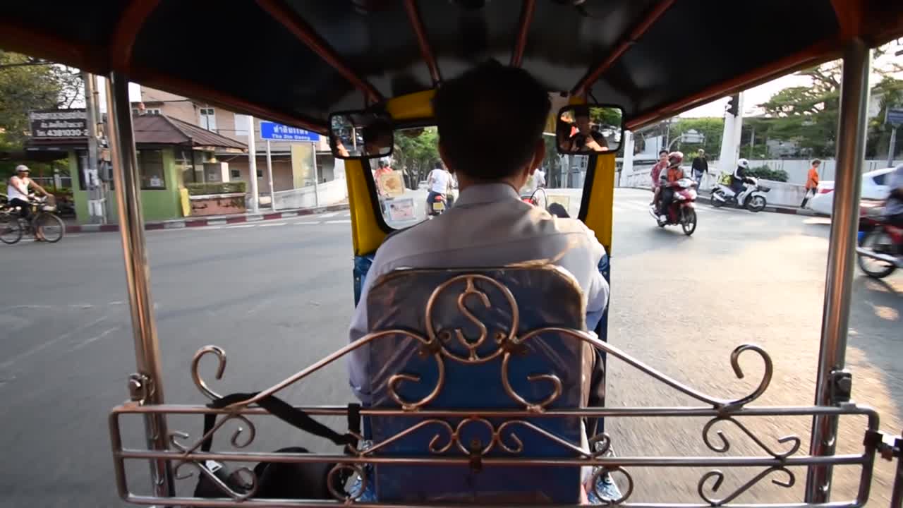 Point of view shot from back of tuk-tuk driving through Bangkok, slow motion