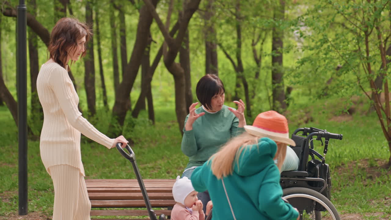 Helpful Guiding Aids, Compassionate Assistance Given To Wheelchair User With Family Nearby, Kindhearted Individual Helping Disabled Man Walk Through Peaceful Park Setting With Loved Ones