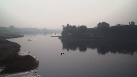 Water-has-dried-out-in-rivers,-Foggy-weather-view,-camera-panning-up,-Trees-arround-the-river