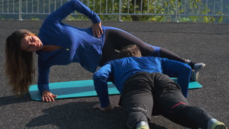 woman doing a side plank exercise outdoors