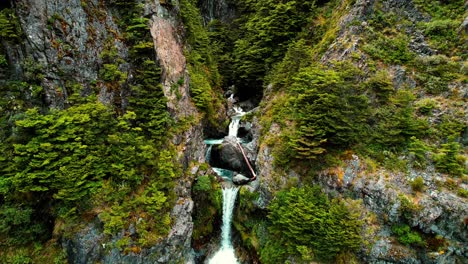 new zealand drone aerial of devil’s punchbowl waterfall, flying through stream