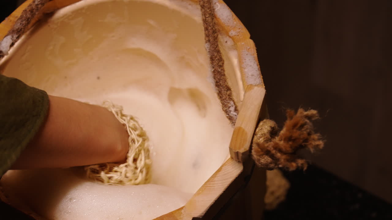 Washing with a Natural Sponge in a Wooden Bucket