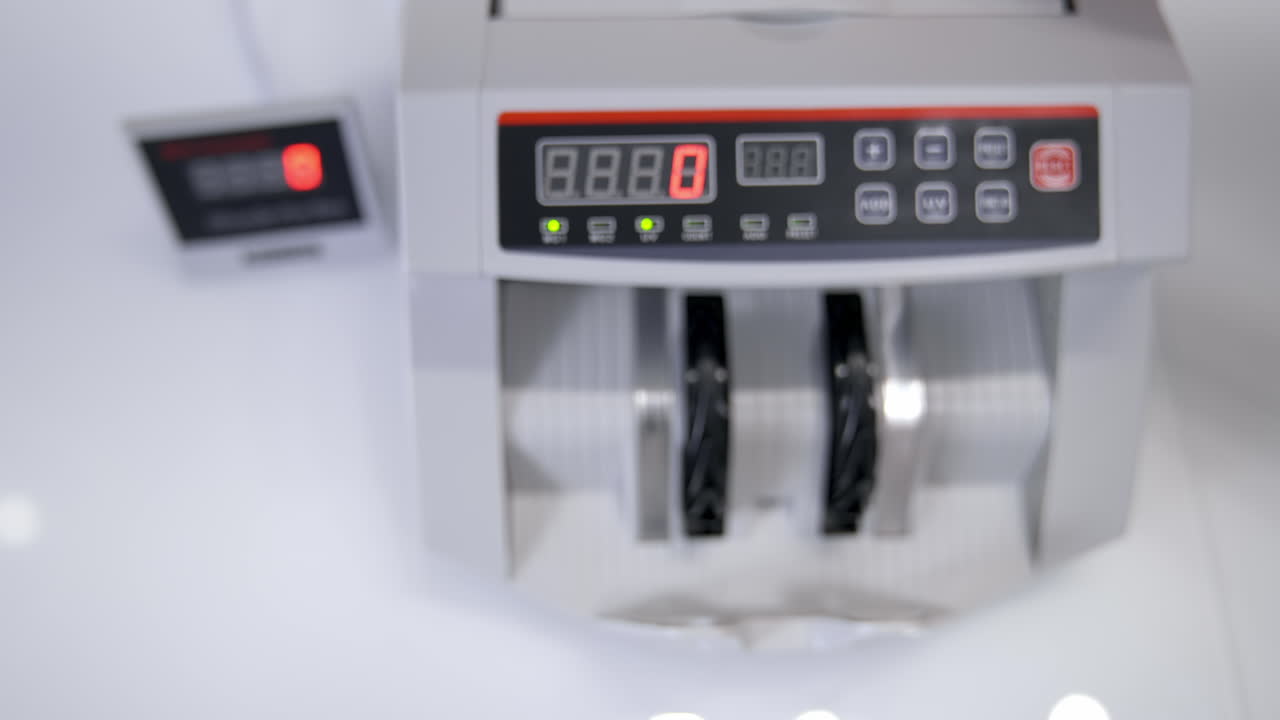 Euro bills going through the counting mechanism, close up