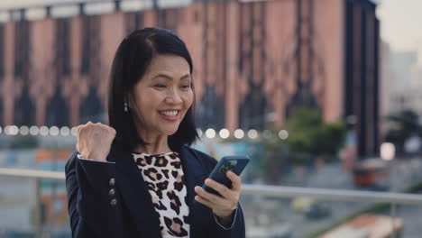 Happy Business Woman Celebrating Success on Smartphone