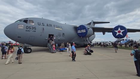 the u.s. air force c-17 globemaster aircraft on display at an airshow, with attendees boarding and exploring the interior.