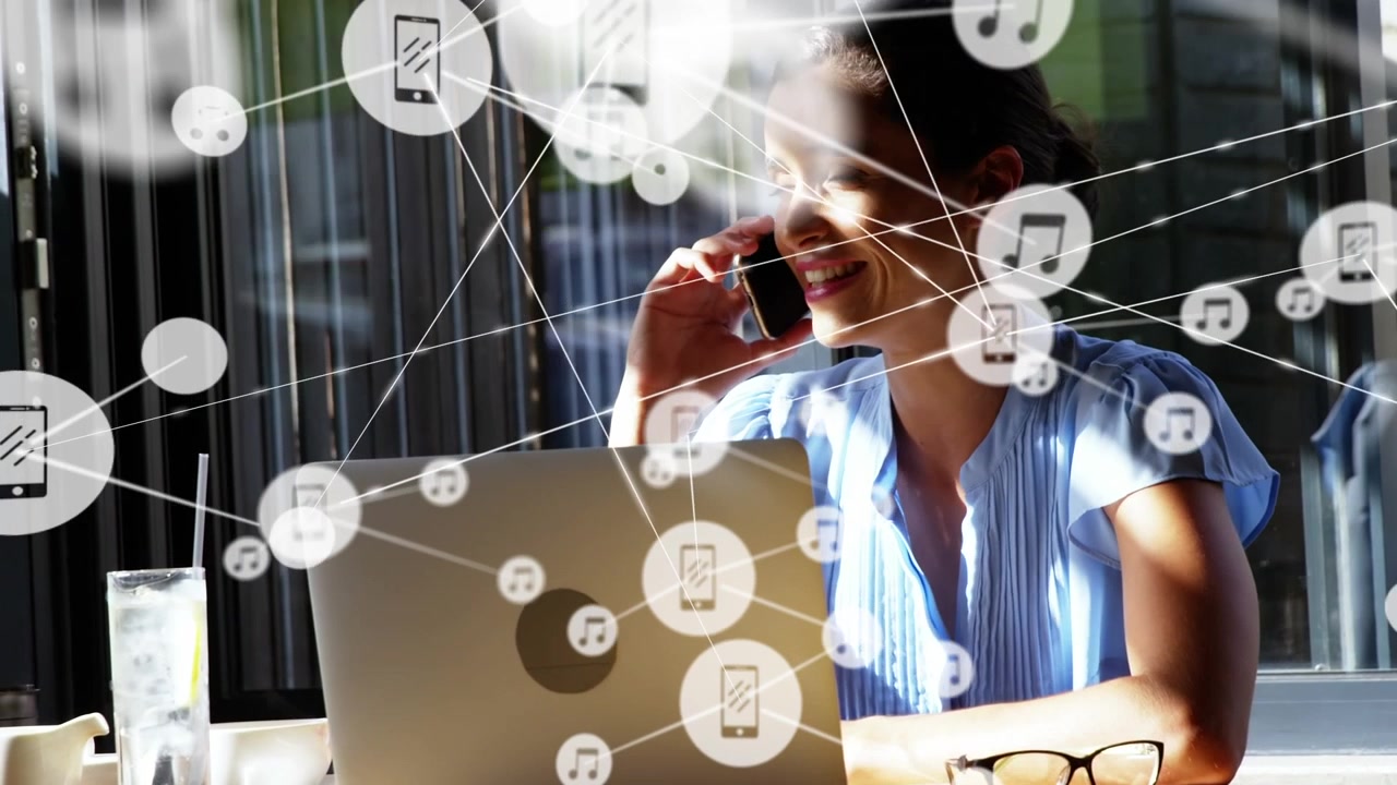 Animation of network of connections with icons over businesswoman talking on smartphone
