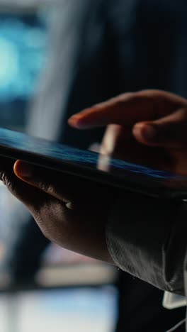 vertical video data center programmers check ai dashboard using tablet, doing systems review