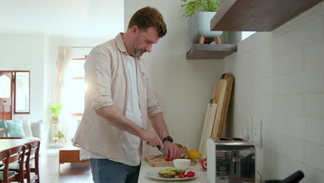 senior man preparing breakfast in kitchen, slicing bread with fresh ingredients nearby, at home