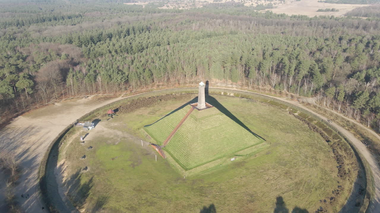 Drone pulling away from Austerlitz pyramid on a sunny day. The Piramide van Austerlitz is a monument in the Netherlands, built in 1804 as a tribute to Napoleon Bonaparte.
