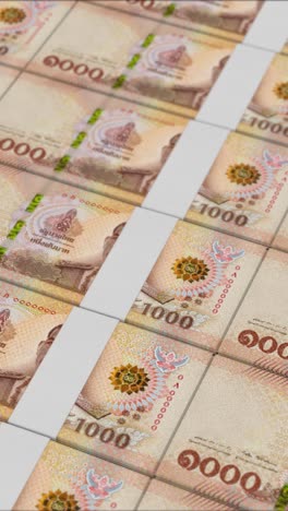 vídeo vertical de billetes de 1000 baht tailandeses impresos por una prensa de dinero