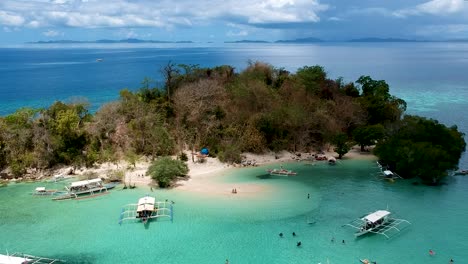 aerial establishing shot of cyc beach on cyc island, coron town, philippines