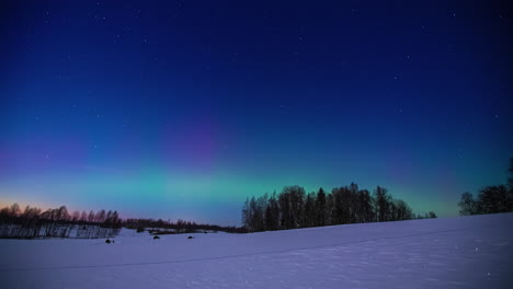 shimmering glow of the aurora borealis over a northern winter wilderness - time lapse