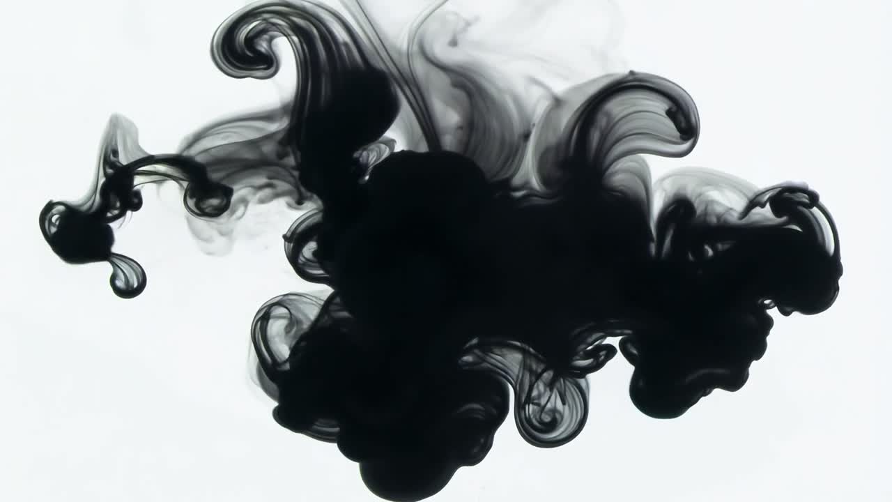 Black ink dissolves into a white background, creating an abstract shape with fluid motion and dynamic textures
