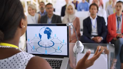 Female-speaker-adressing-the-audience-at-a-business-conference