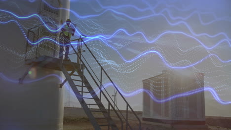 male technician inspecting wind turbine platform with digital data waves showing renewable energy