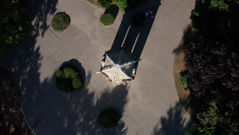 aerial ascending top-down shot of gothic tower - landmark in bratislava, capital of slovakia - summer sunny day