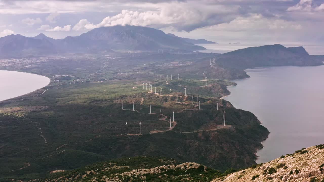 Aerial view of wind power plant field among sea bays and mountains near Kızlan village, Mediterranean Turkey
