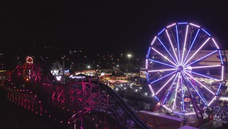 drone fly towards the fun fair rides at the washington state fair in puyallup, washington, usa